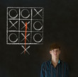 Thinking out of the box man on blackboard background