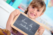 Photo: Little girl writing on chalkboard Little girl writing on chalkboard