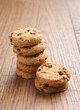 stack of chocolate biscuits with chocolate on wooden table