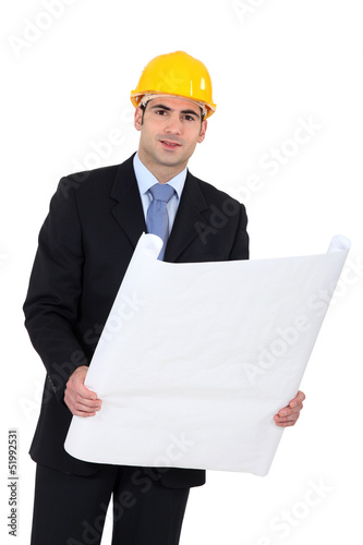 Photo: Architect in suit with blueprints Architect in suit with blueprints