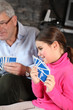 little girl playing cards with grandfather