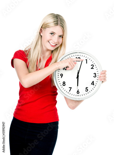 Photo: young woman with a clock isolated on white young woman with a clock isolated on white