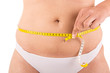 Fat woman measuring her body
