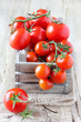 Delicious red ripe tomatoes on the vine in a crate