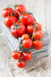 Delicious red ripe tomatoes on the vine in a crate