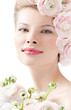 fashion model with hairstyle and pink flowers in her hair.