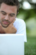 Photo: Using his laptop in park Using his laptop in park