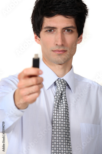 Photo: businessman holding a flash drive businessman holding a flash drive