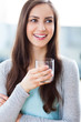 Woman holding glass of water