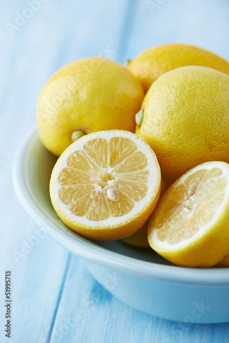 Photo: Lemons in a bowl; whole and halved Lemons in a bowl; whole and halved