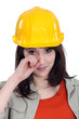 Foto: cute young female apprentice wiping tears cute young female apprentice wiping tears
