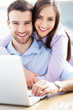Young couple using laptop
