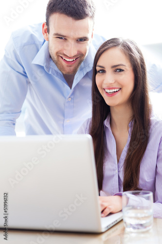 Photo: Business people using laptop Business people using laptop