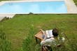 Woman reading book poolside