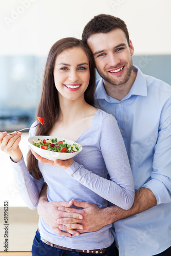 Photo: Couple in modern kitchen Couple in modern kitchen