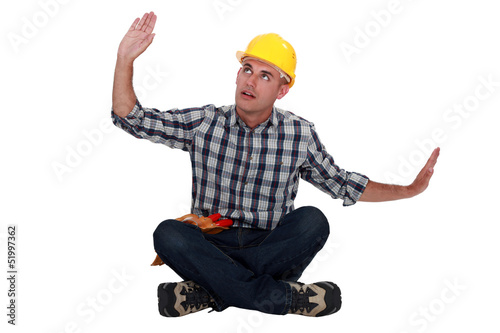 Photo: Workers sitting with arms outstretched Workers sitting with arms outstretched
