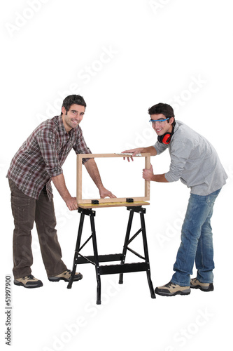 Photo: Tradesmen building a wooden frame Tradesmen building a wooden frame