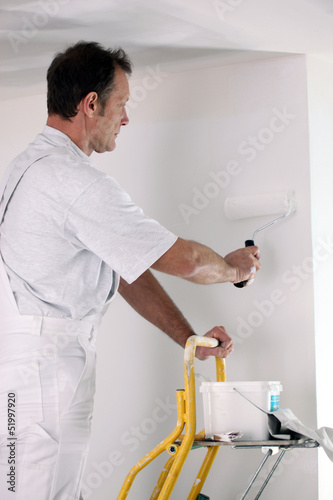 Photo: Decorator working on DIY project Decorator working on DIY project