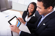 Two Businesspeople Looking At  Digital Tablet