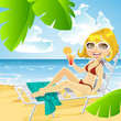 Cute girl lying on a sun lounger on the beach with a cocktail