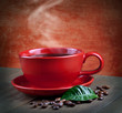 cup of fresh coffee with coffee beans on wooden table