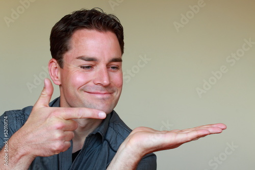 Photo: Pointing with one forefinger to other palm of hand Pointing with one forefinger to other palm of hand