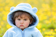 portrait of a boy in spring flowers field
