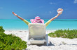 Girl with a shell on the sunbed looking to the ocean. Exuma, Bah