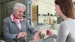 Senior woman buying glasses at optician