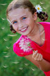 Summer joy - lovely girl blowing dandelion