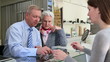 Senior man buying eyeglasses at optician