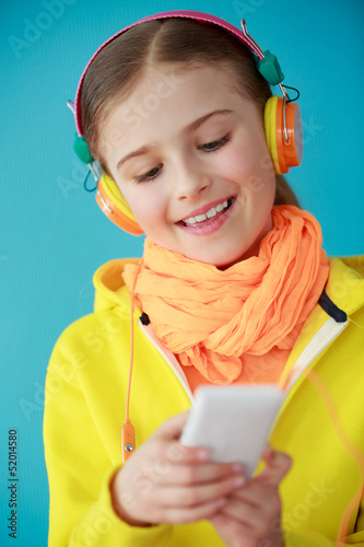 Photo: Young girl with headphones listening music Young girl with headphones listening music