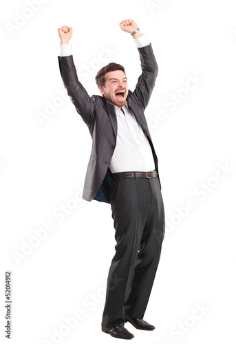 Photo: Excited handsome business man with arms raised in success Excited handsome business man with arms raised in success