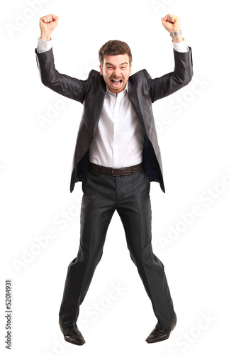Photo: Excited handsome business man with arms raised in success Excited handsome business man with arms raised in success