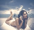 Photo: Girl listens to music at the beach Girl listens to music at the beach