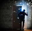 Young businessman opening door