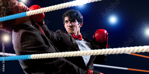 Photo: Two young businessman boxing Two young businessman boxing