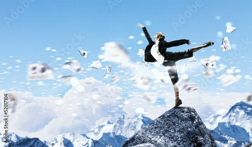 Photo: businesswoman standing atop of mountain businesswoman standing atop of mountain