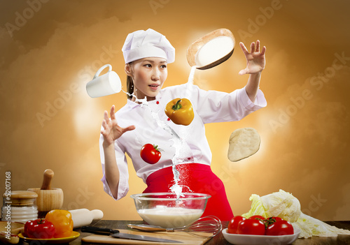 Photo: Asian female cooking with magic Asian female cooking with magic