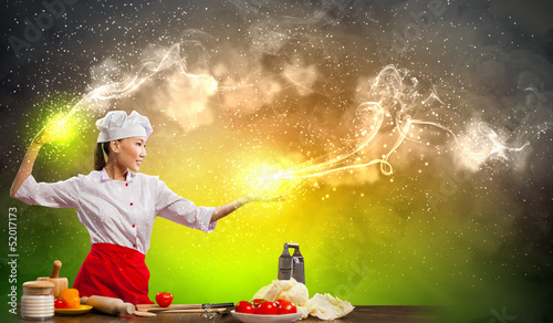 Photo: Asian female cooking with magic Asian female cooking with magic