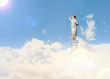 Businesswoman standing on ladder
