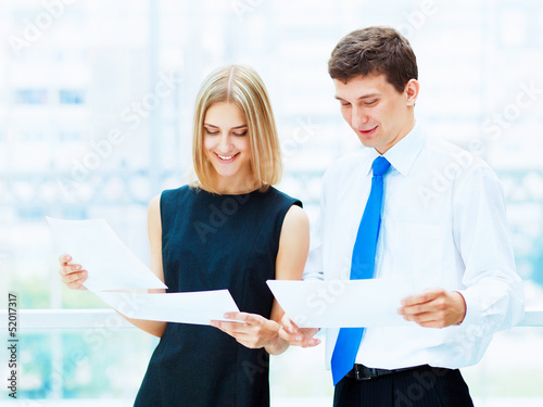 Photo: Two young business collegues. Two young business collegues.