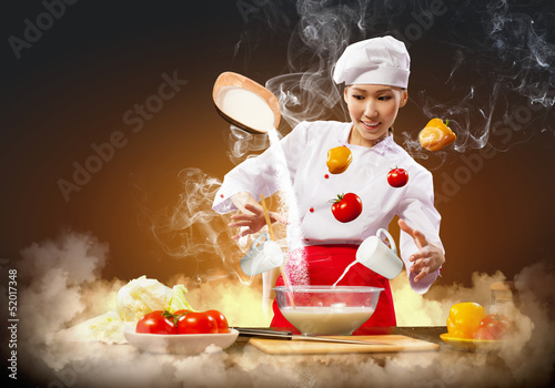 Photo: Asian female cooking with magic Asian female cooking with magic