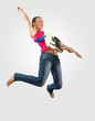 Photo: young woman playing on electro guitar and jumping young woman playing on electro guitar and jumping