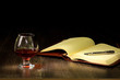 Photo: Cognac, cigar and an old book nearby Cognac, cigar and an old book nearby