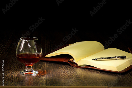 Photo: Cognac, cigar and an old book nearby Cognac, cigar and an old book nearby
