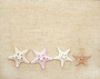 Foto: Starfishes on canvas texture Starfishes on canvas texture