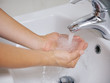 Foto: Closeup on woman washing hands in sink Closeup on woman washing hands in sink