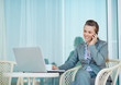 Happy business woman talking mobile phone on terrace