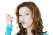 Portrait of woman with spoon in her mouth